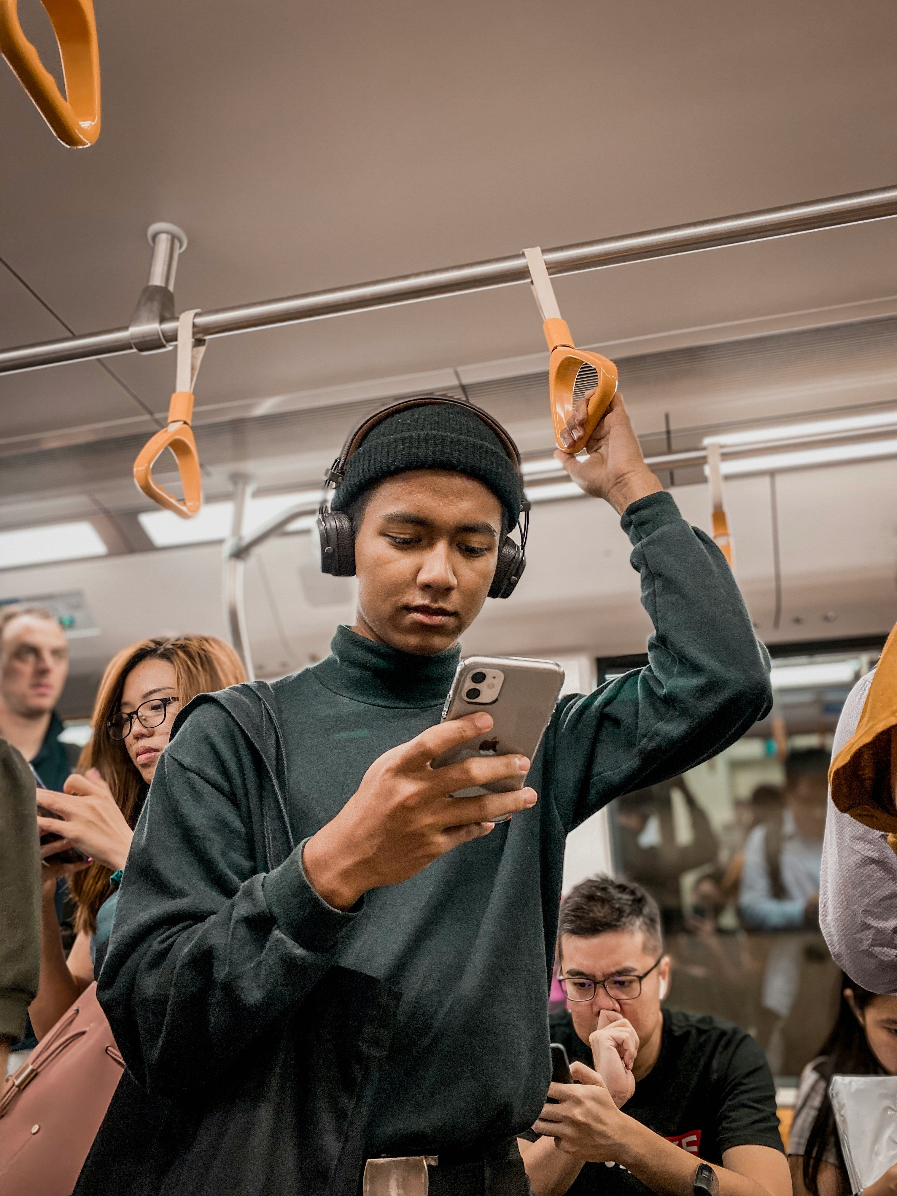 Person using a smartphone on public transit, illustrating intuitive and engaging app design.