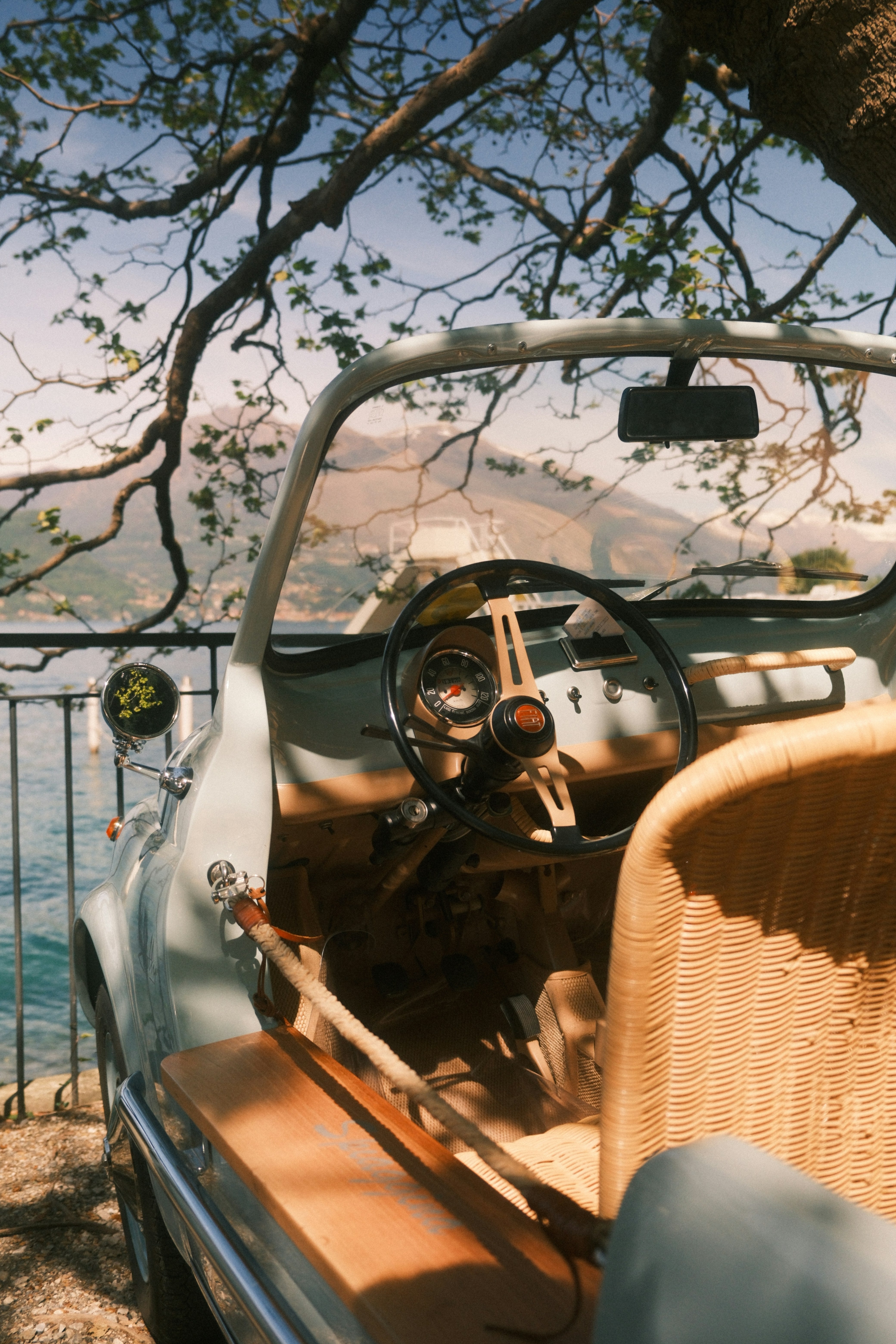 image of a classic car overlooking a lake. 